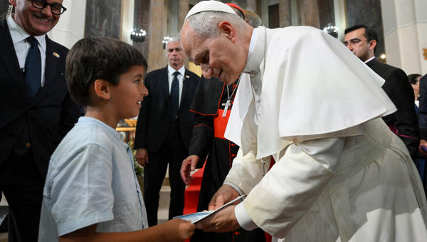 Pope Leo XIV greeting a kid during a meeting with Diocesan charity and welfare organizations in the Church of Sant Augusti in Montserrat