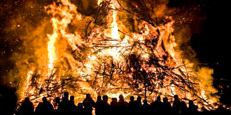 HUGE BONFIRE,PEOPLE SURROUNDING