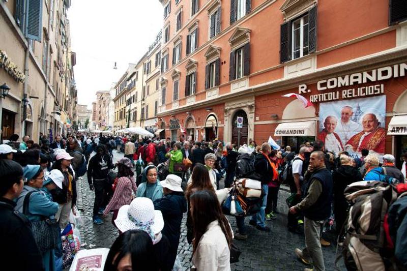 April 27, 2014: Pilgrims walking to Borgo Pio at the end of the canonization ceremony that will see John Paul II and John XXIII recognized as saints, on Saint Peter's Square in the Vatican, Rome, Italy.