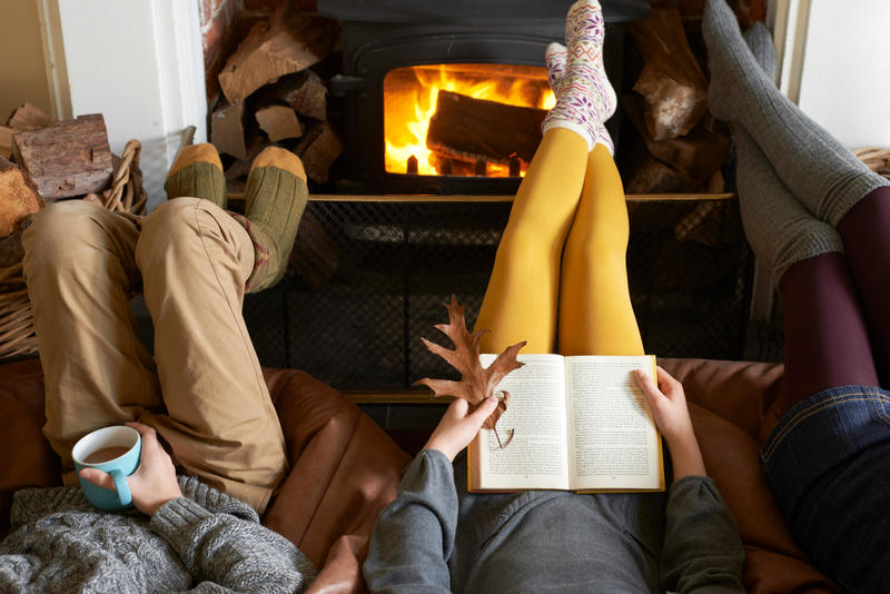 Children relaxing by fire