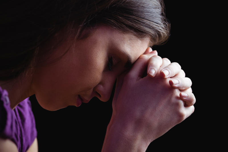 web-woman-praying-hands-wavebreakmedia-shutterstock_317872571