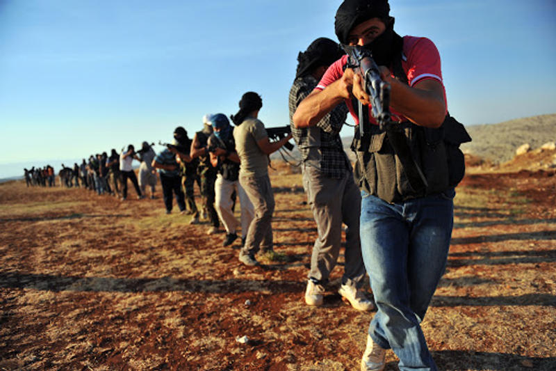 Members of Jihadist group Hamza Abdualmuttalib train near Aleppo on July 19, 2012
