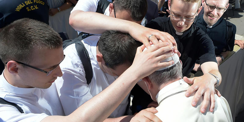 Neoprezbiterzy modlą się nad papieżem Franciszkiem