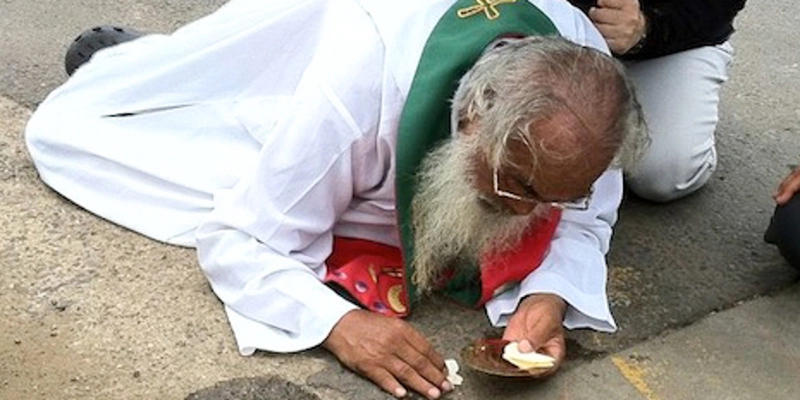 MAN ON GROUND WITH EUCHARIST