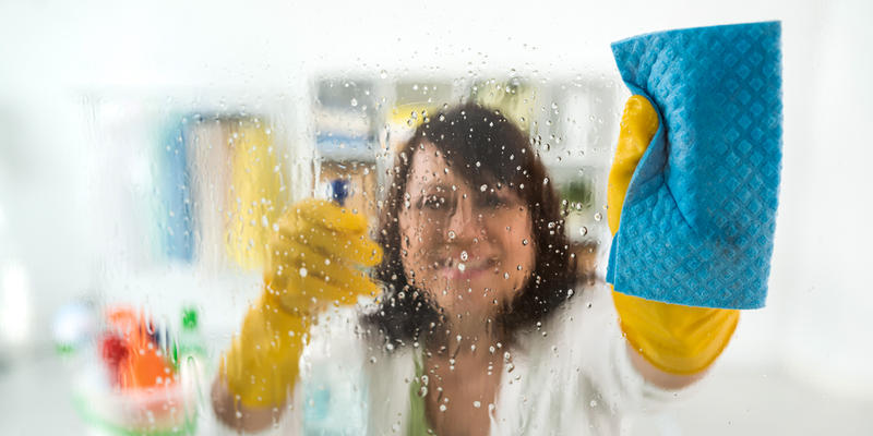 WOMAN CLEANING GLASS