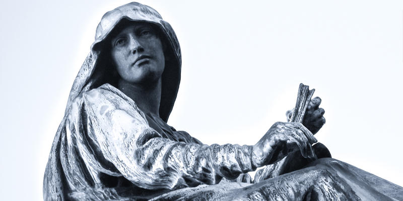 STATUE OF WOMAN HOLDING BIBLE