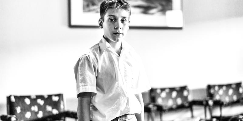 YOUNG BOY LOOKING INTO CAMERA