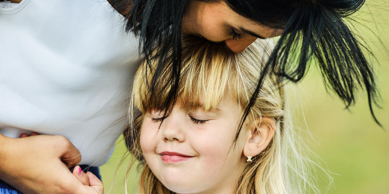MOTHER EMBRACING CHILD