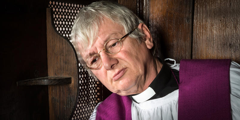 PRIEST IN CONFESSIONAL