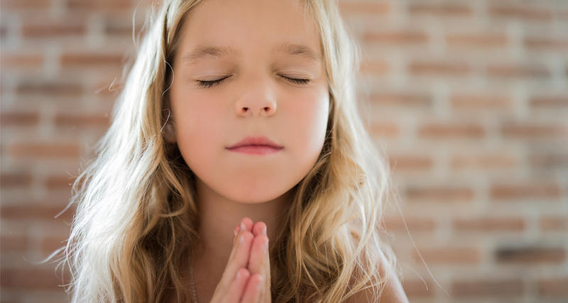 YOUNG GIRL PRAYING