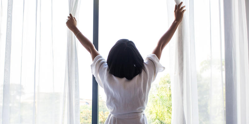 WOMAN OPENING WINDOW