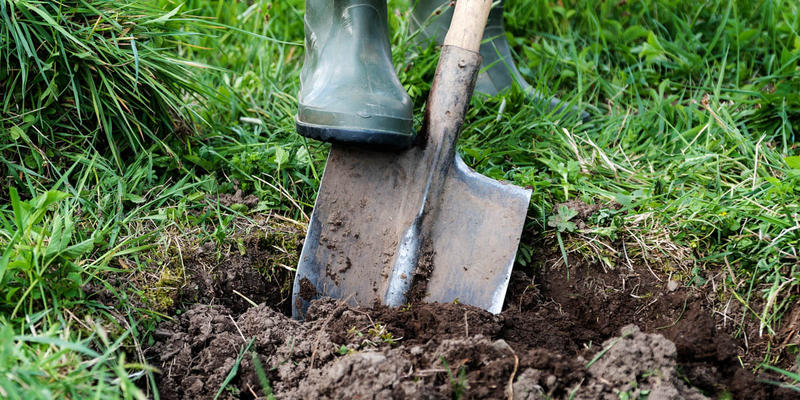 MAN DIGGING HOLE