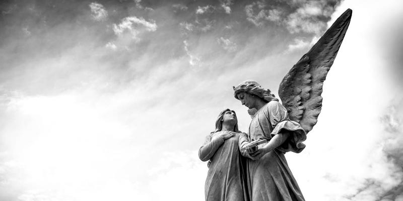 WOMAN WITH ANGEL SCULPTURE