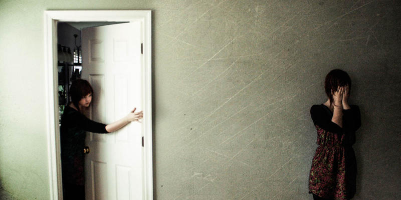 GIRL IN HALLWAY,GIRL LOOKING OUT OF DOOR