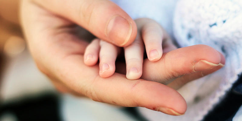 PARENT HOLDING CHILD'S HAND