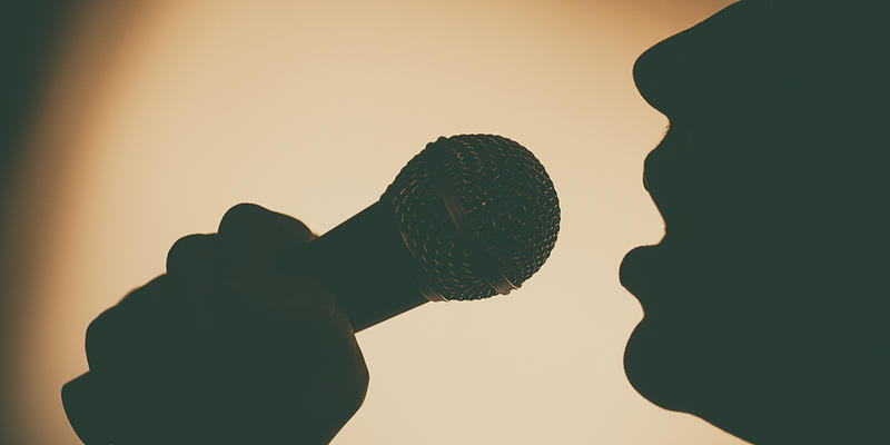 SINGING INTO MICROPHONE