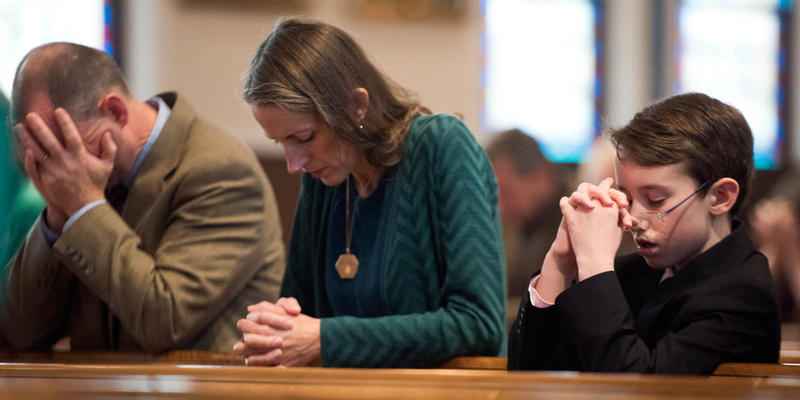 PEOPLE PRAYING IN CHURCH