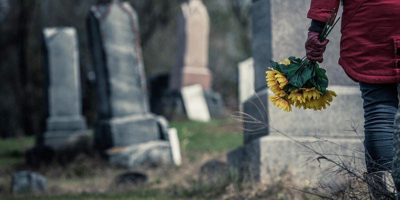 WOMAN,FLOWERS,CEMETERY