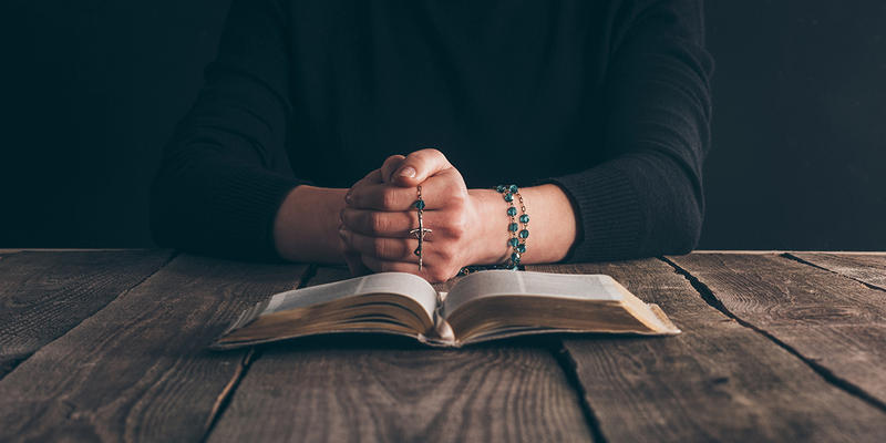Woman Praying rosary
