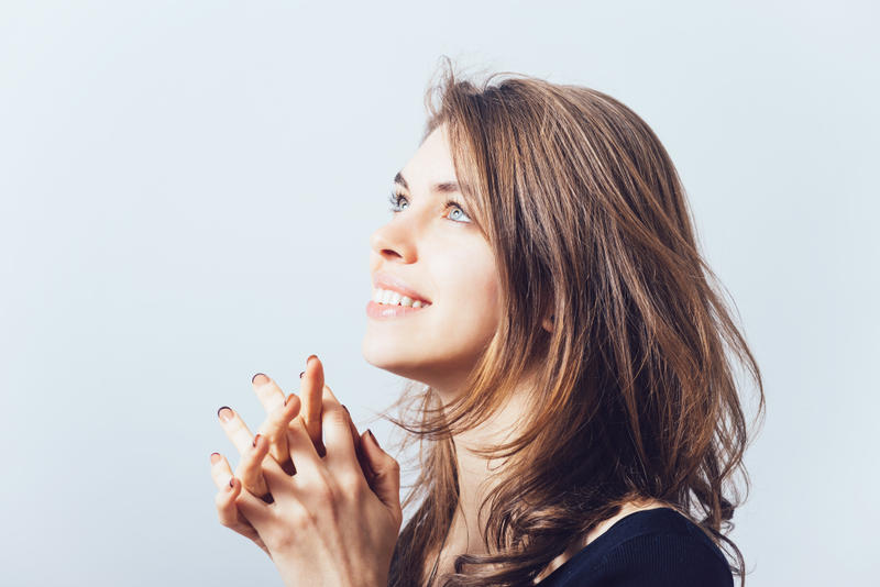 WOMAN PRAYNG SMILING