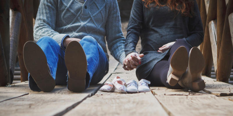 COUPLE SITTING,HOLDING HANDS