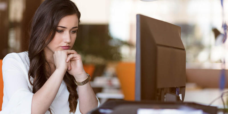 WOMAN SITTING AT DESK
