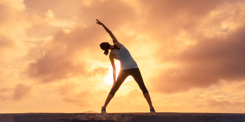 WOMAN,STRETCHING,SUNSET