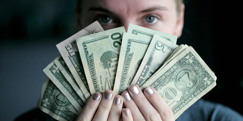 WOMAN HOLDING MONEY