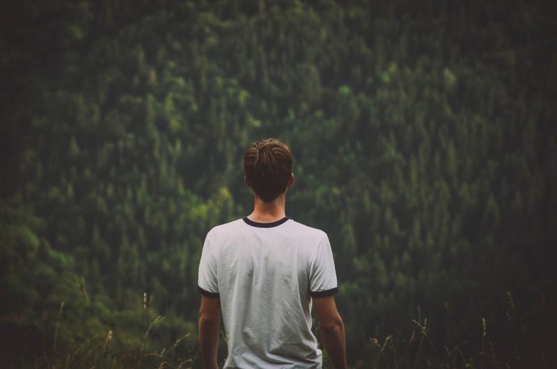 YOUNG MAN OVER A FOREST