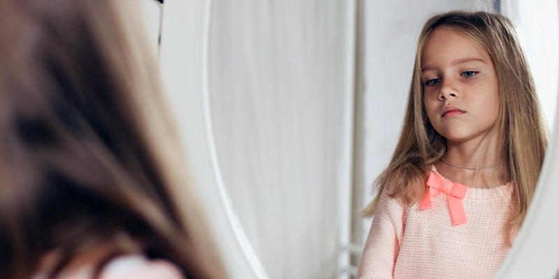 CHILD LOOKING AT REFLECTION