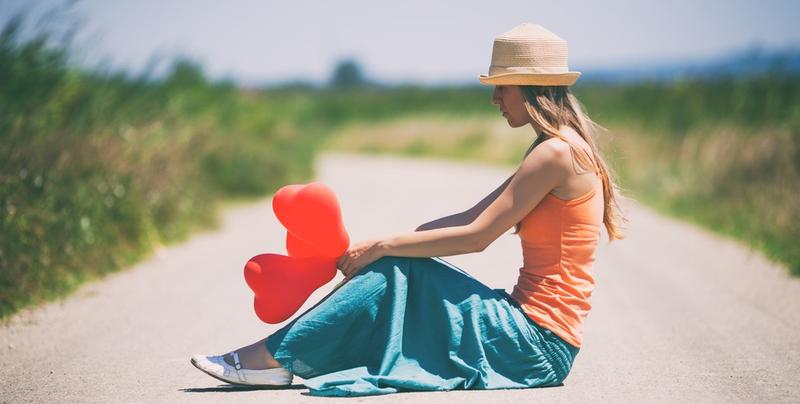 WOMAN SITTING ON THE ROAD