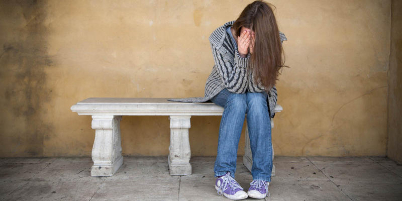 GIRL SITTING ALONE