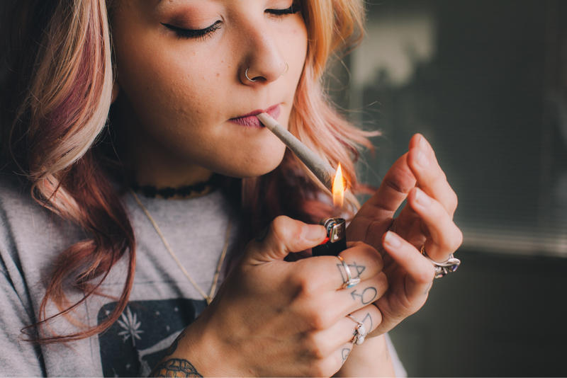 WOMAN SMOKING CANNABIS