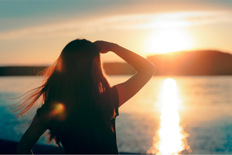 woman looking at the sunset