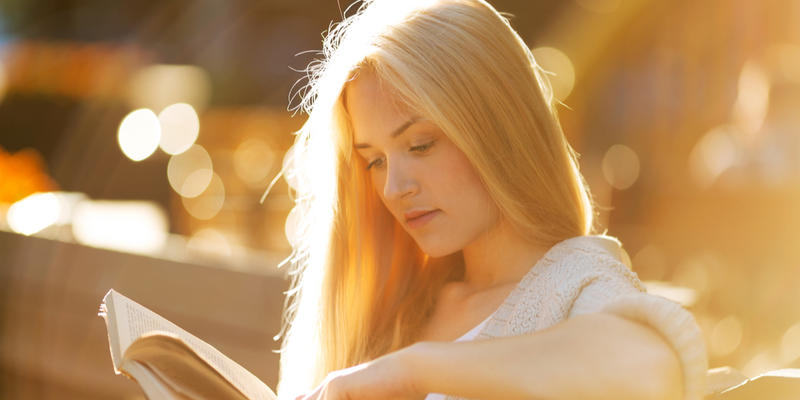 girl sitting and reading book