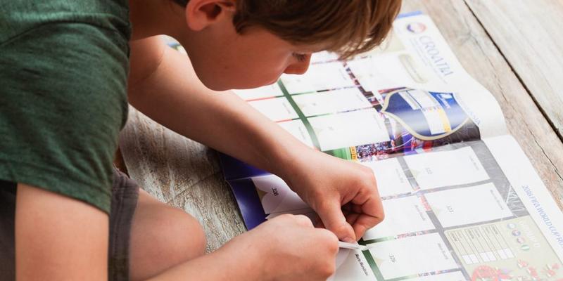 CHILD COLLECTING STICKERS
